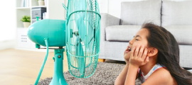 girl on floor with fan