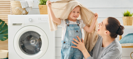 mom and child near clothes washer