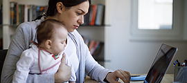 mom and baby looking at laptop