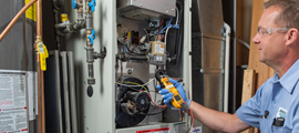 ServiceChoice technician inspecting furnace