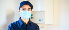 technician wearing a mask holding a clipboard